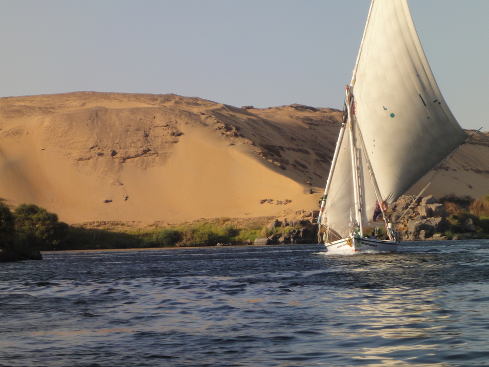 A traditional felucca floats along The Nile in Aswan, Egypt.
