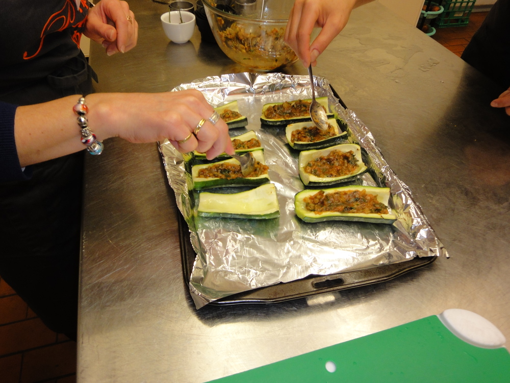 Stuffing the zucchinis before they go in the oven.