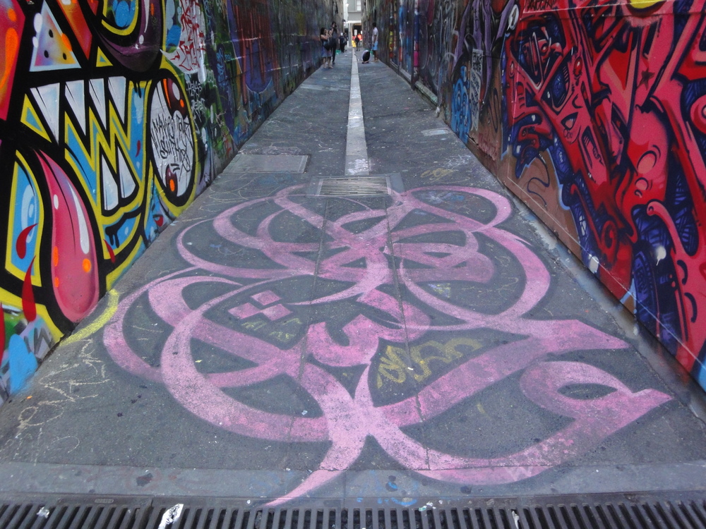 eL Seed's calligraffiti adorns the entrance of one of Melbourne's street art laneways.