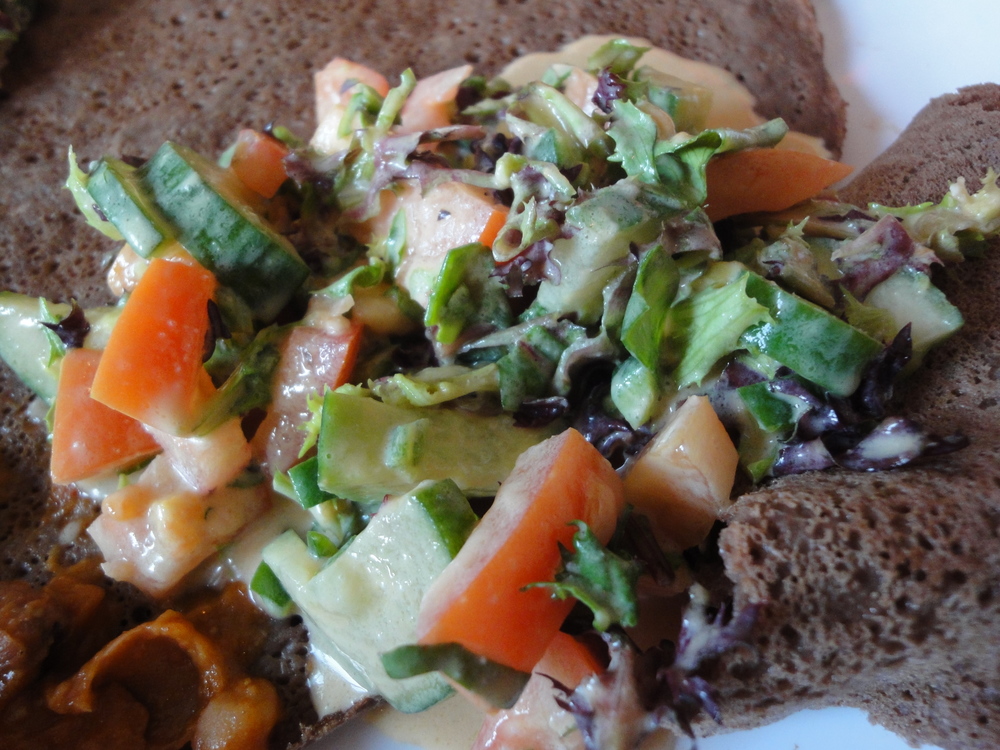 Breaking injera bread with good friends over a vegan banquet at Saba's Ethiopian Restaurant in Fitzroy, Victoria.